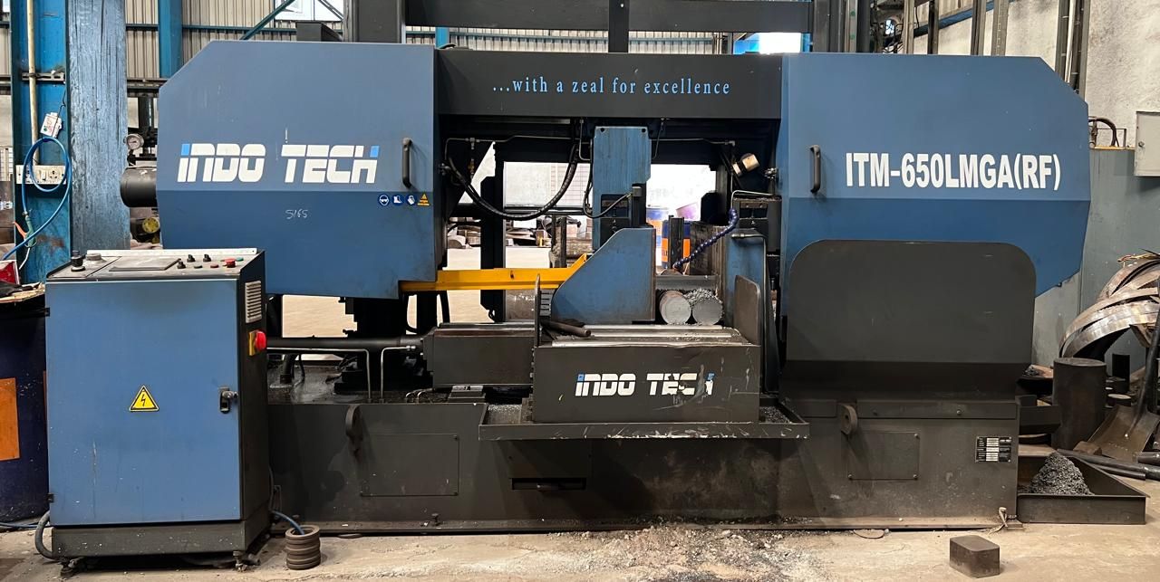 Band saw cutting a steel bar to length