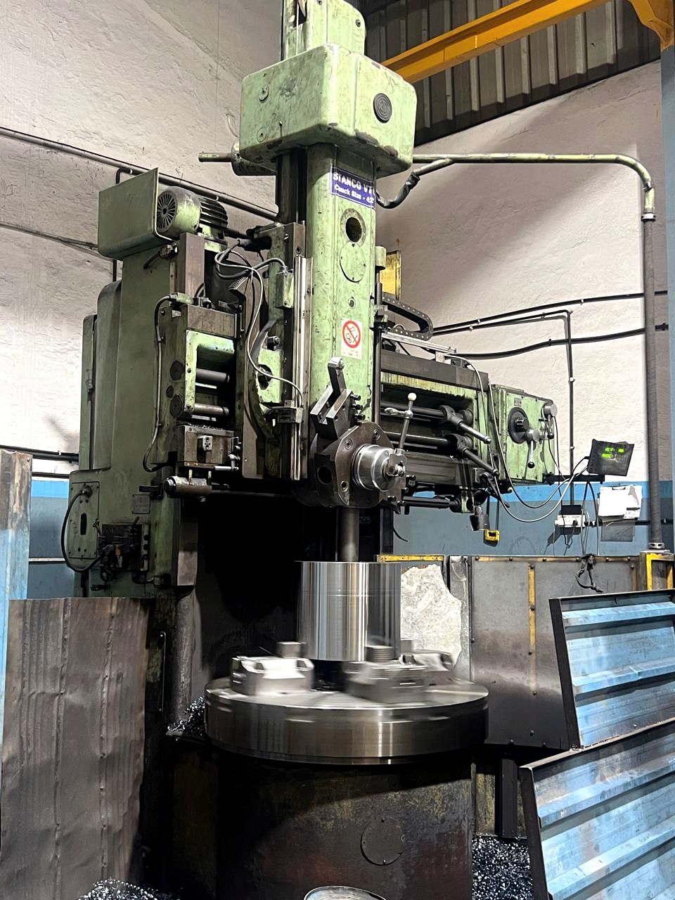 Vertical turret lathe machining a forged component